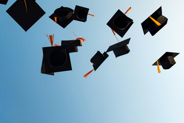 graduation caps in air
