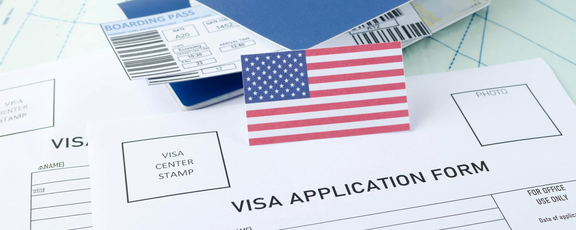 Concept of getting legal American visa. American flag passports tickets and empty visa application form on the map