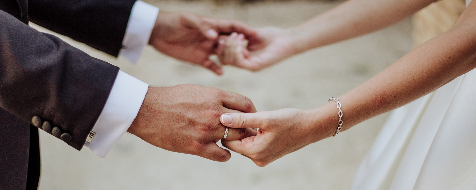 couple holding hands at wedding ceremony