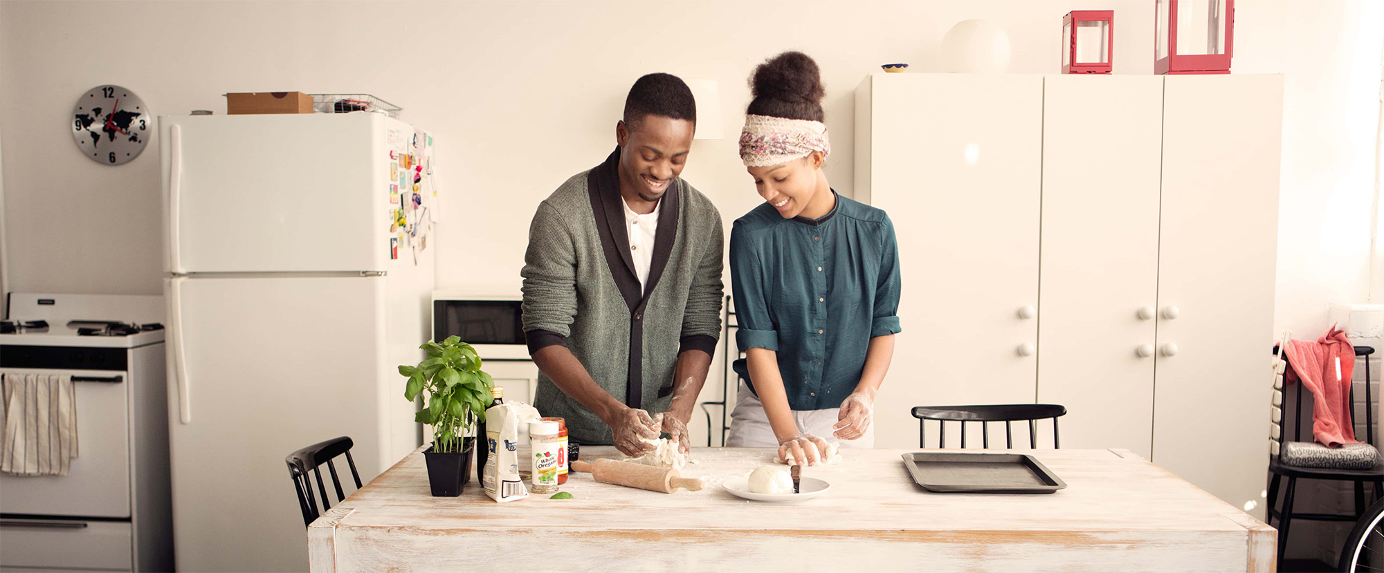 couple working in the kitchen making dough