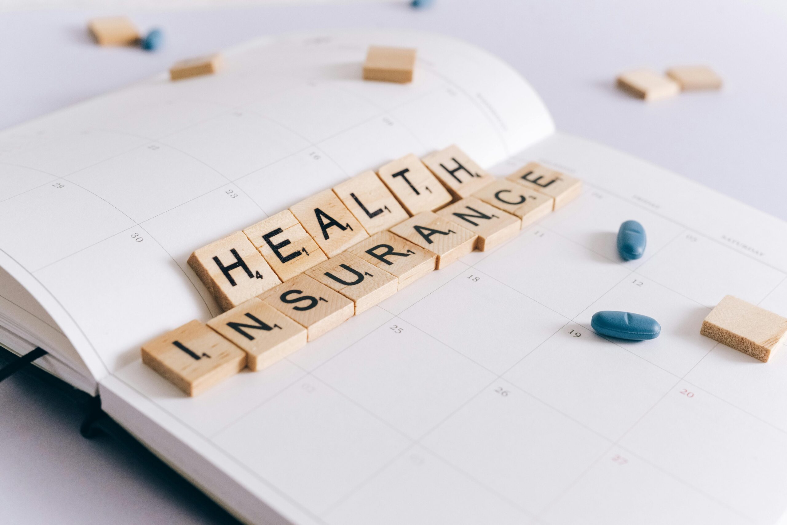 scrabble pieces that say health insurance